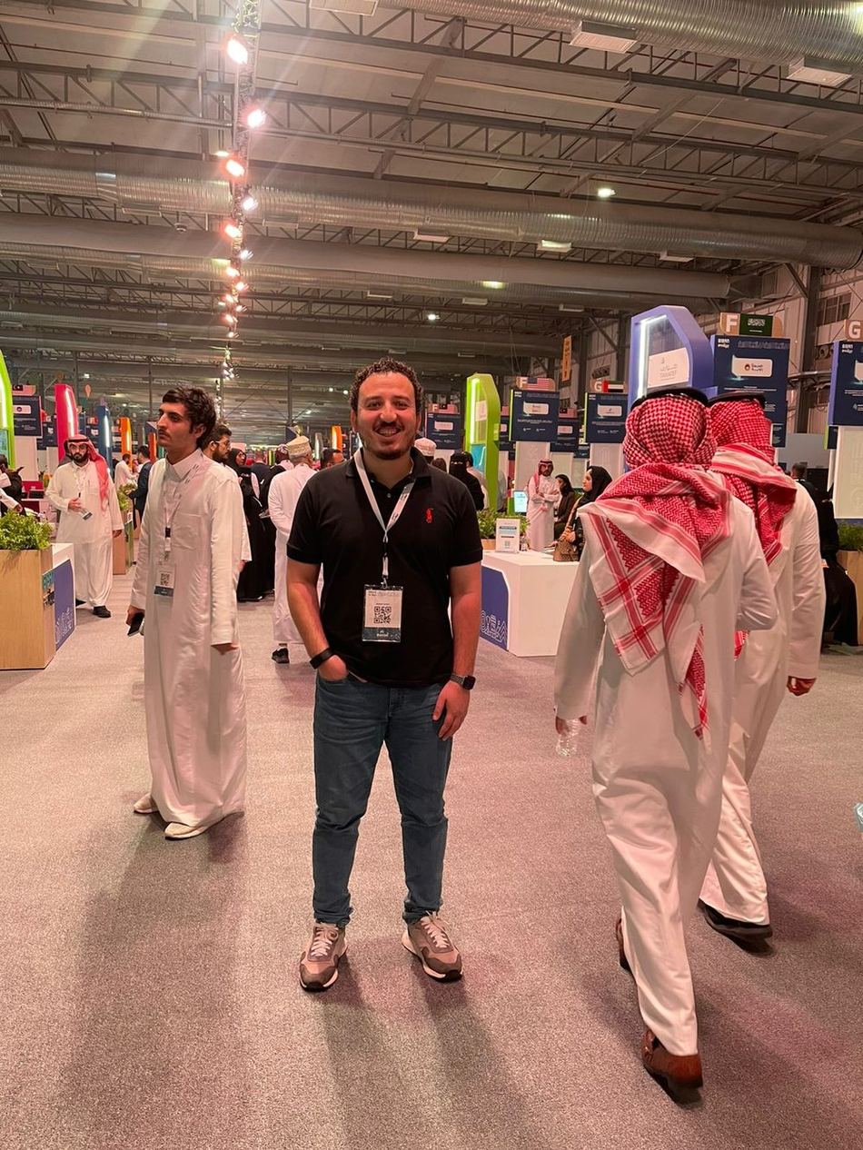 Ahmed Assem networking on a conference floor